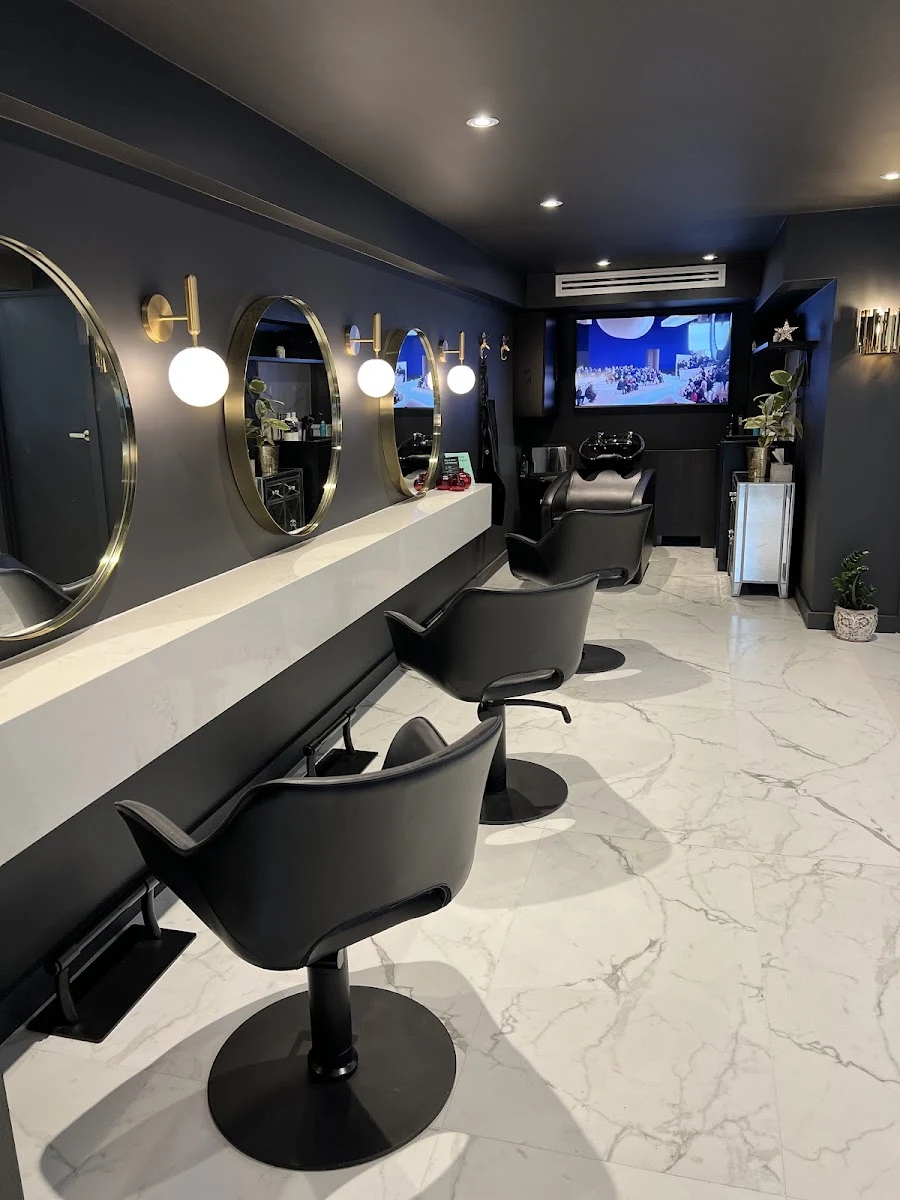 Jayrun Beauty House interior with round brass mirrors and charcoal walls